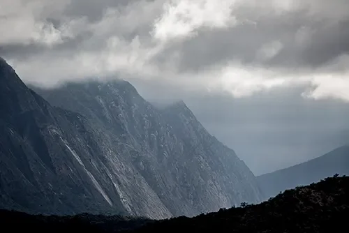mountain partly covered by clouds