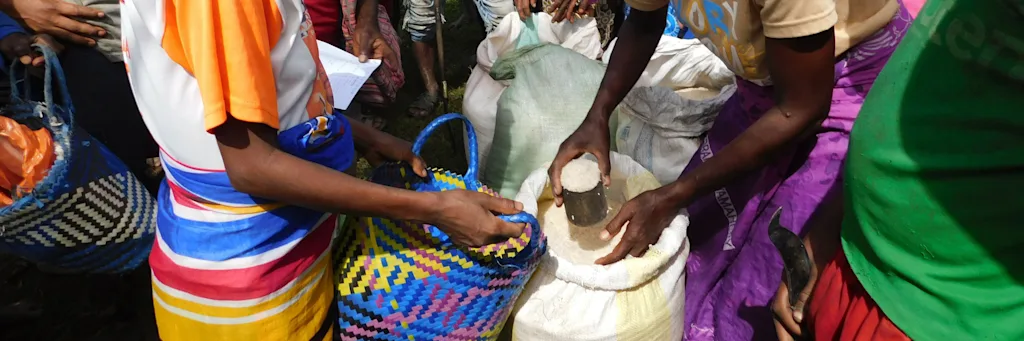 people putting grains in containers