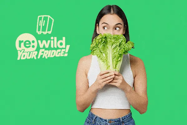 woman holding head of lettuce